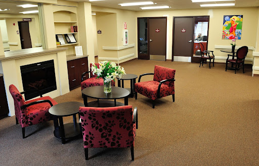 A cozy waiting area with comfortable chairs and a decorative table.