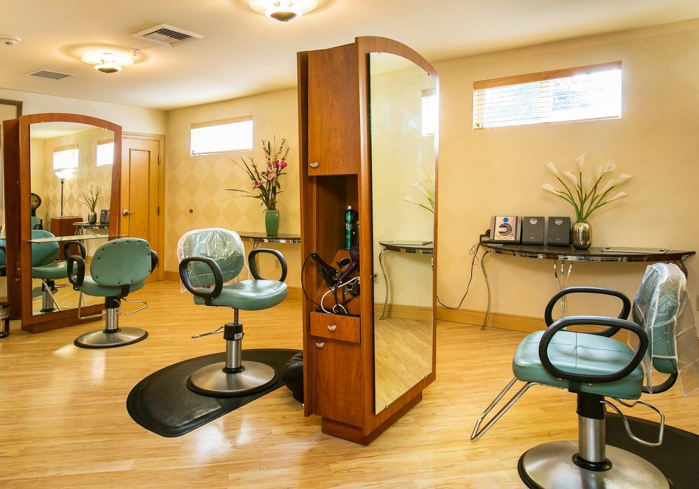 A modern hair salon with styling stations and mirrors.