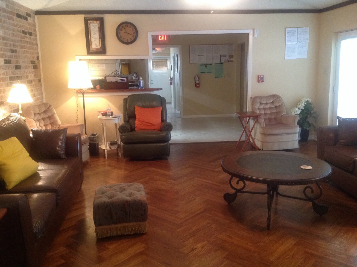 A cozy living room with various seating options and a coffee table.