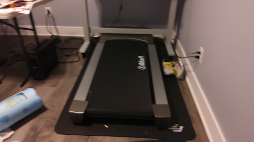 A compact treadmill set up in a home environment, ready for workout sessions.