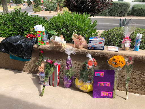 A collection of flowers and gifts displayed outdoors, perfect for a special occasion.