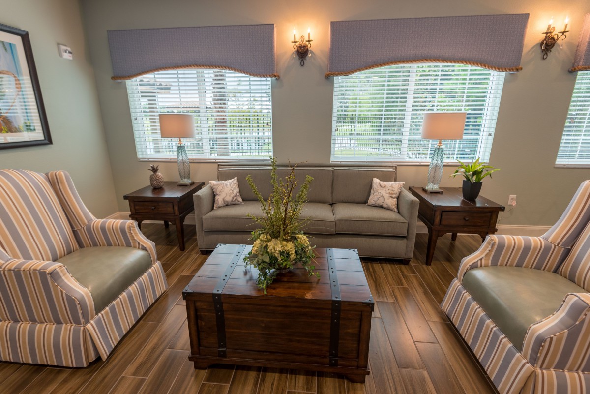 A cozy living room with a sofa set, coffee table, and ambient lighting.