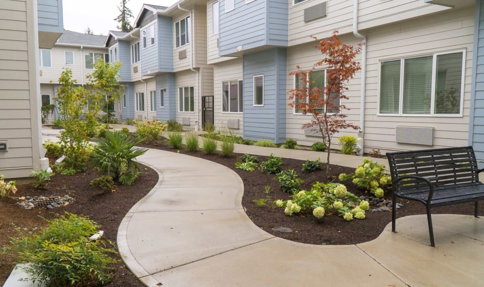 A well-maintained apartment complex with a landscaped pathway.