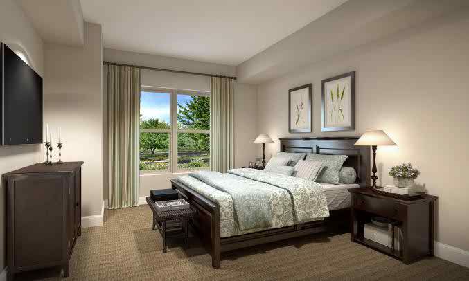 A cozy bedroom with a large bed, two lamps, and artwork on the walls.