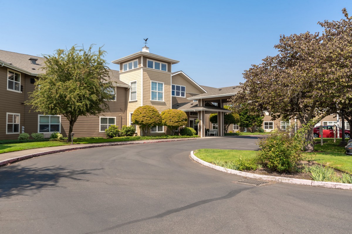 A well-maintained building with landscaped surroundings on a sunny day.