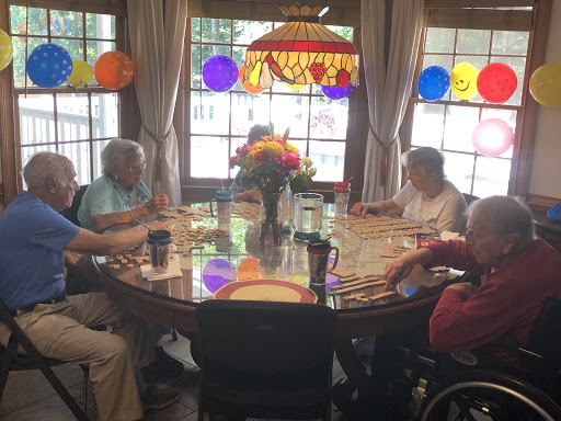 A group of seniors enjoying a meal together in a warmly decorated dining area.