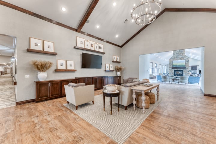 A modern living room with stylish furniture, warm wood flooring, and elegant decorations.