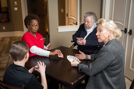 A group of individuals enjoying a card game together, fostering social interaction and engagement.