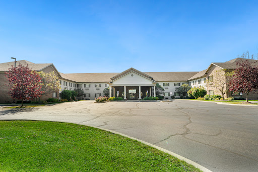 A well-maintained residential building with a welcoming entrance surrounded by lush greenery.