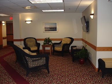 A cozy lobby area with wicker furniture and decorative elements.