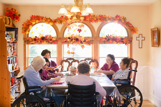 A warm and inviting scene of senior citizens engaging in a group activity, surrounded by autumn decorations.