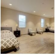 A spacious bedroom with multiple beds and modern furnishings.