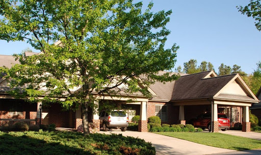 A picturesque residential home surrounded by lush greenery.