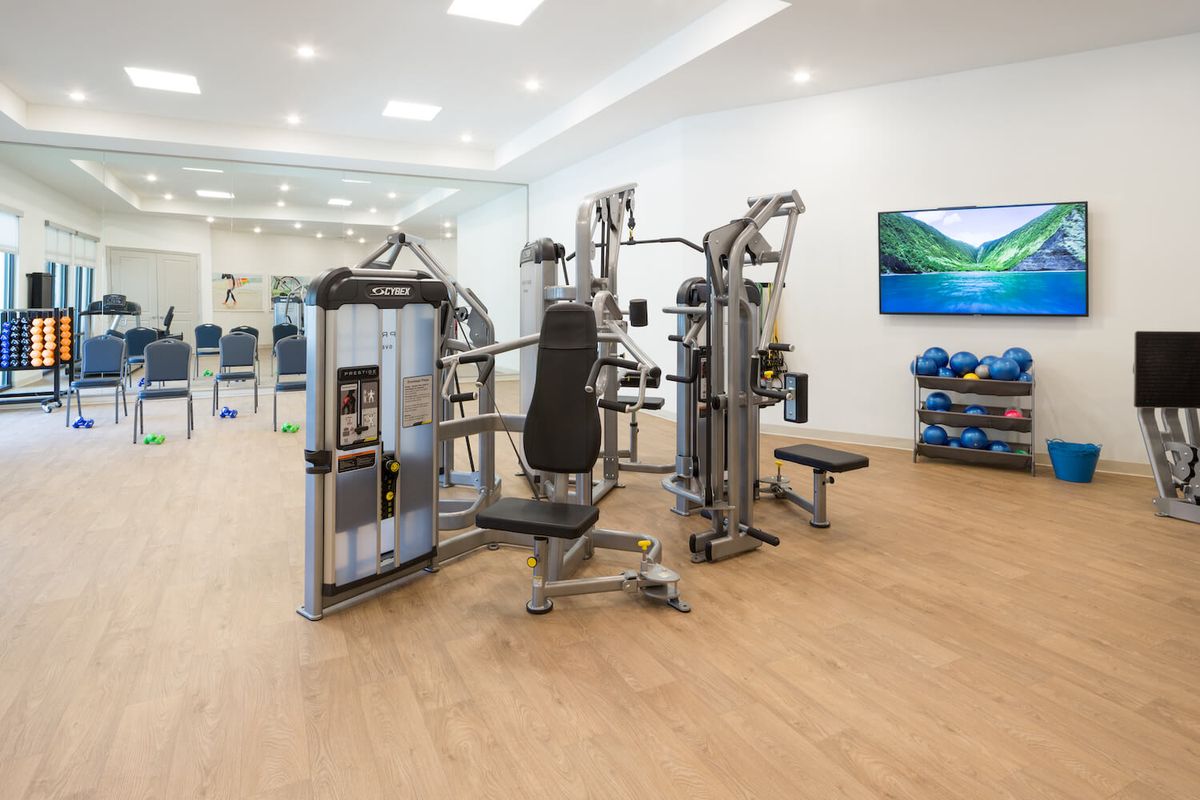 A modern gym equipped with a multi-station exercise machine and other fitness accessories.