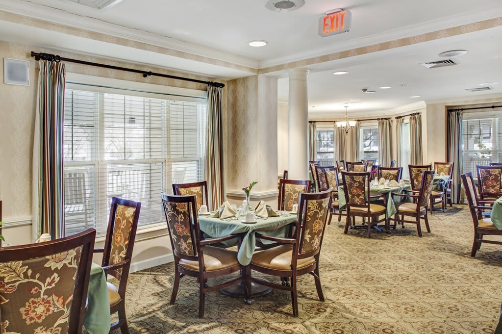 An elegantly decorated dining room with neatly arranged tables and chairs.