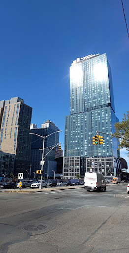 A view of a modern skyscraper against a clear blue sky, showcasing contemporary urban architecture.