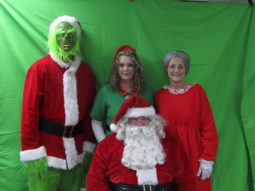 A festive gathering featuring characters like the Grinch and Santa Claus during the holiday season.