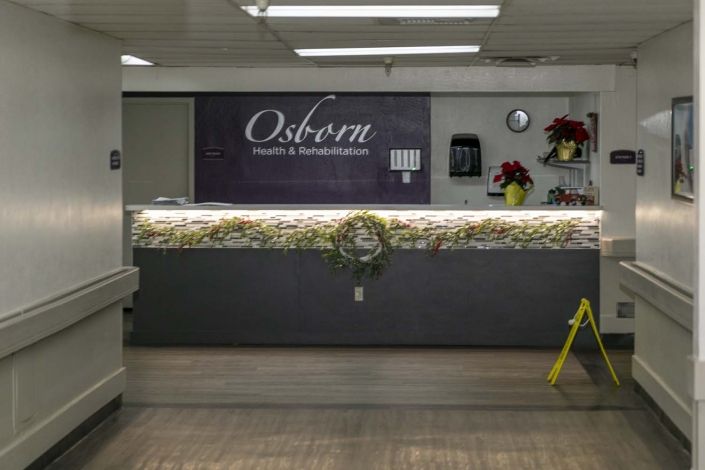 A decorated reception desk with flowers and a sign reading 'Osborn'.