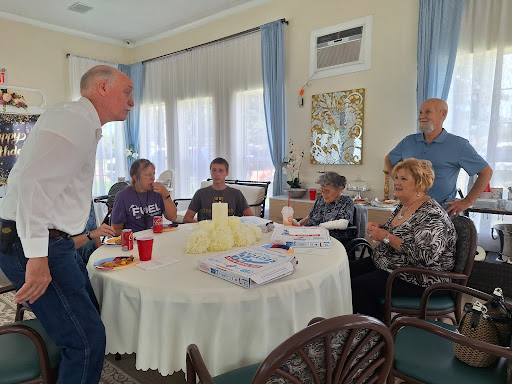 A lively gathering of friends engaged in conversation at a table.