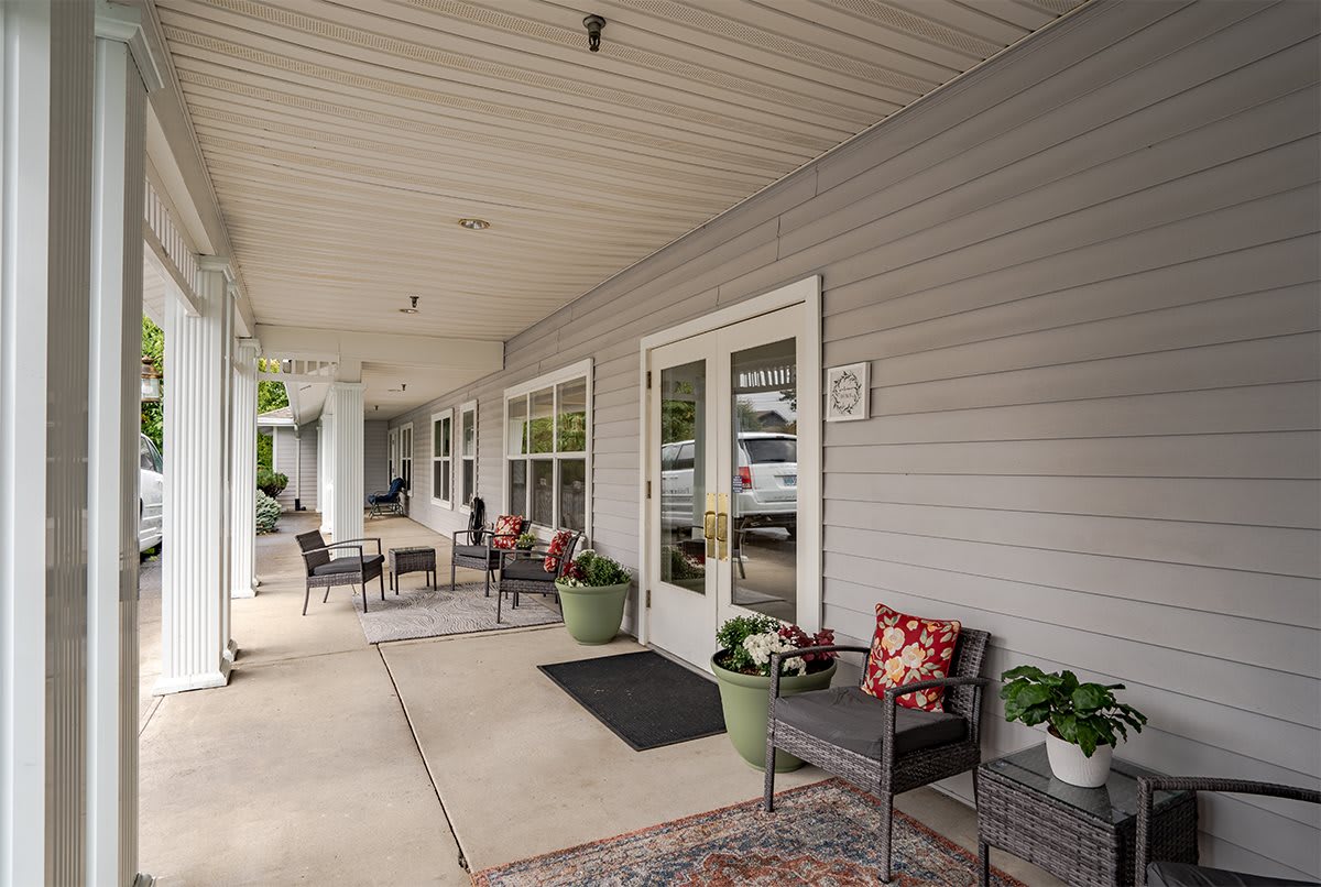 A cozy porch with seating and plants, perfect for relaxation.