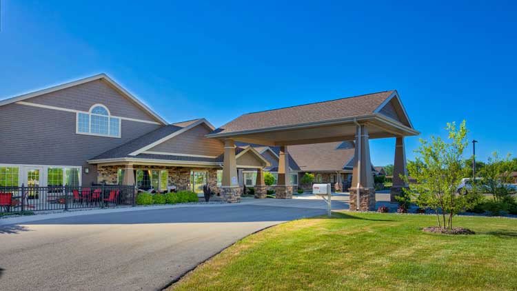 A well-maintained residential building with a covered entrance and manicured landscaping.
