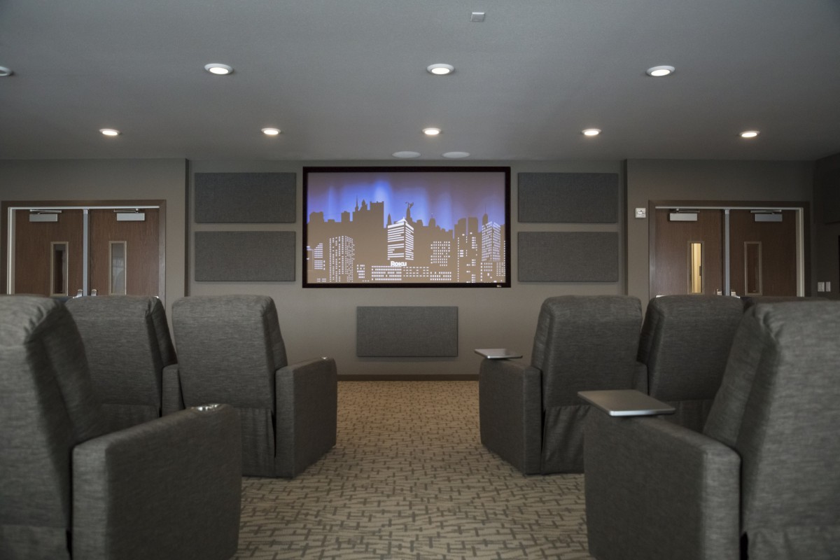 A cozy home theater with comfortable seating and a large screen.