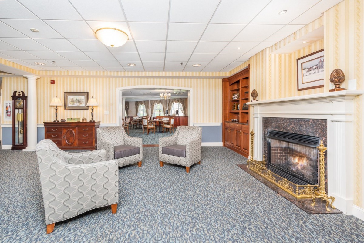 Cozy living room with seating area and fireplace.