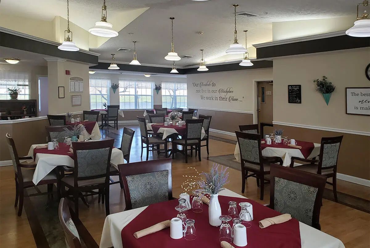 An elegantly set dining area with neatly arranged tables and chairs.