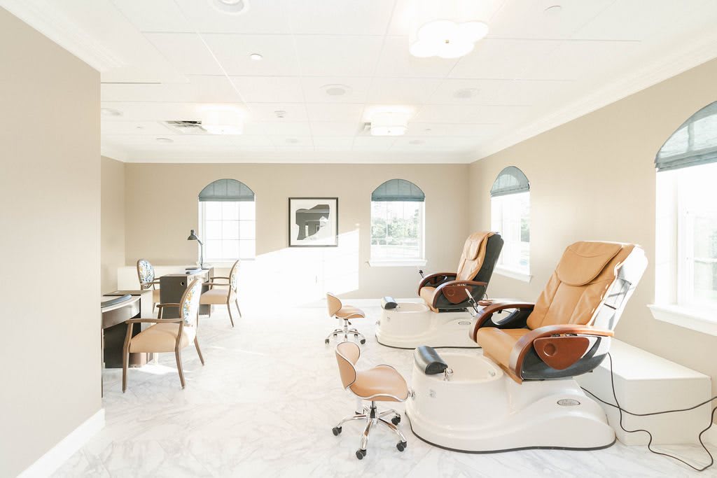 A serene spa interior with massage chairs and bright lighting, perfect for relaxation.
