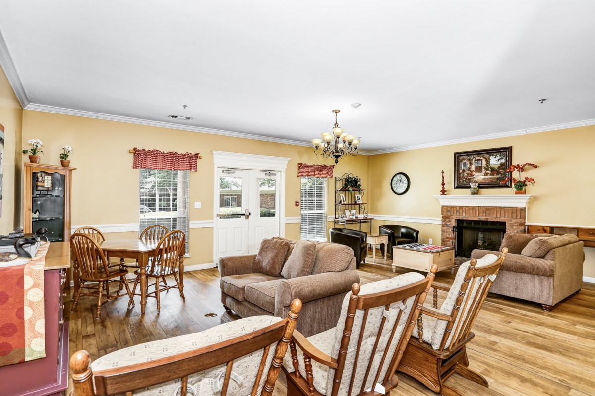 Cozy living room with a fireplace, dining area, and comfortable seating.
