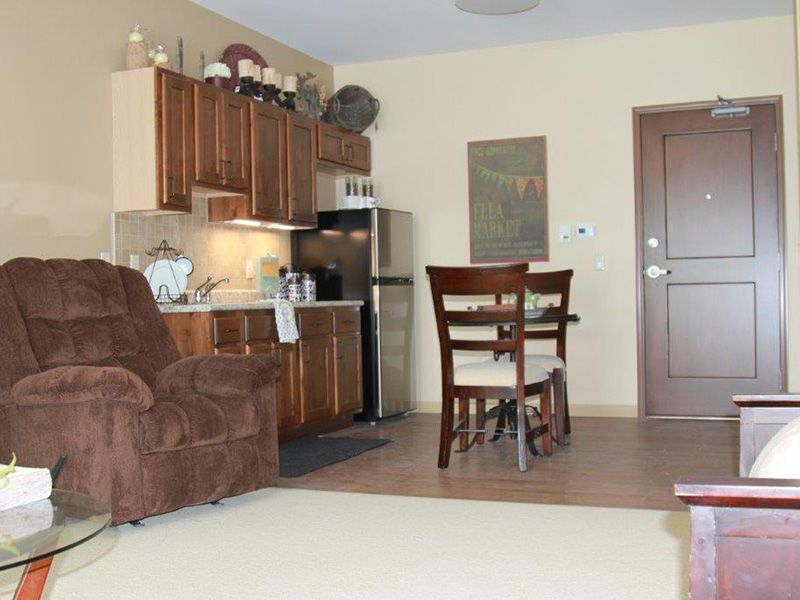 A cozy apartment kitchenette with a dining table and chairs.