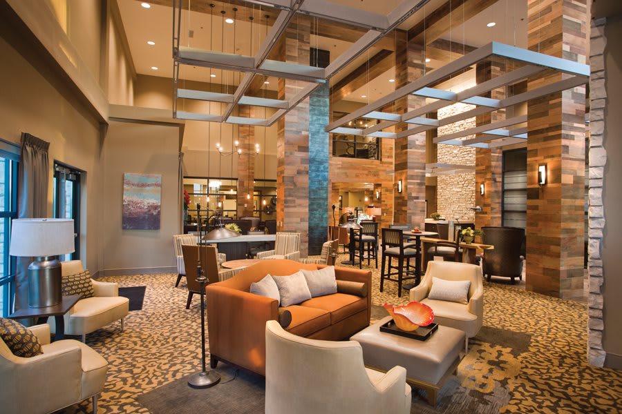 A spacious and elegantly designed hotel lobby with modern furniture and stylish lighting.