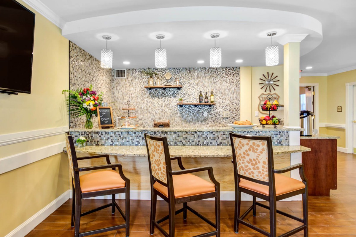 A modern bar area with elegant decor and comfortable seating.