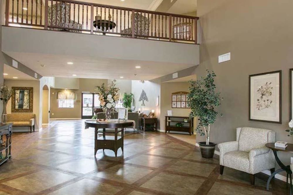 Spacious lobby area with elegant decor and a balcony overlooking the entrance.