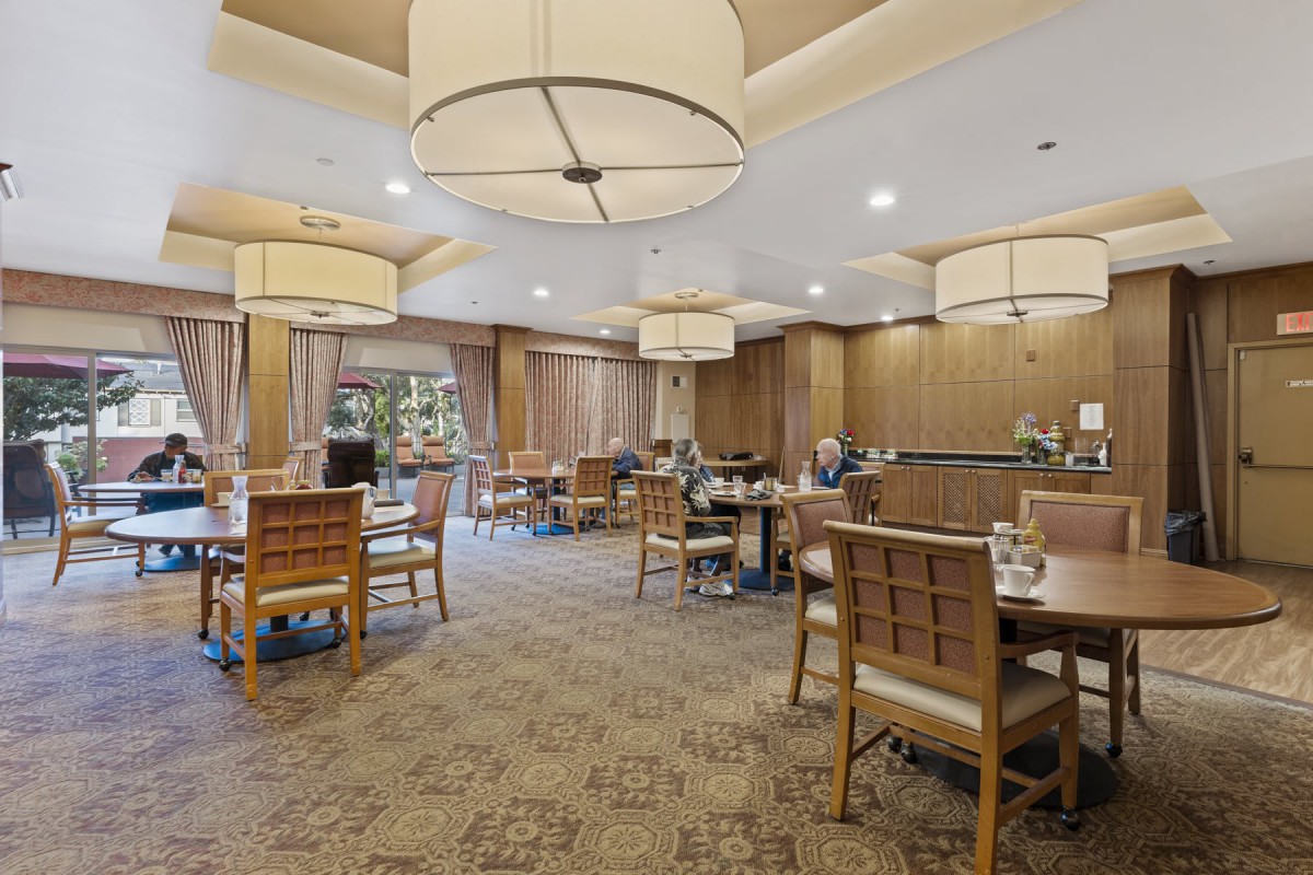A cozy dining area with wooden furniture and warm lighting.