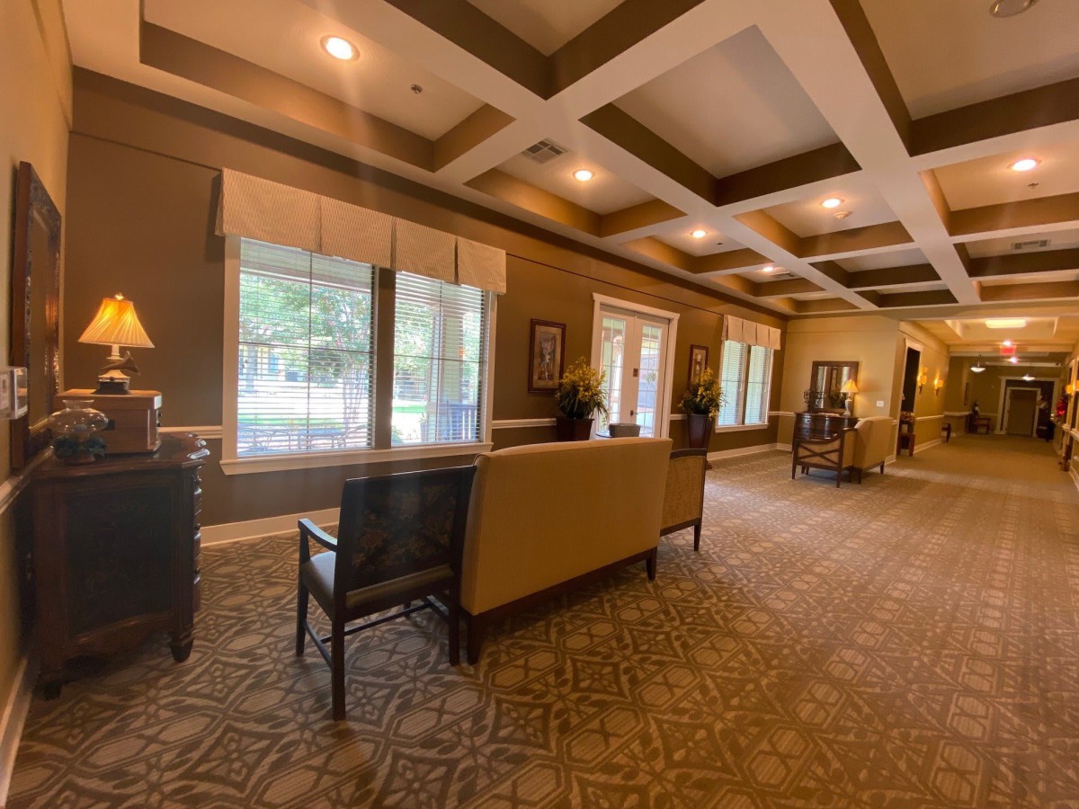 A spacious and elegantly designed lobby with comfortable seating, large windows, and soft lighting.