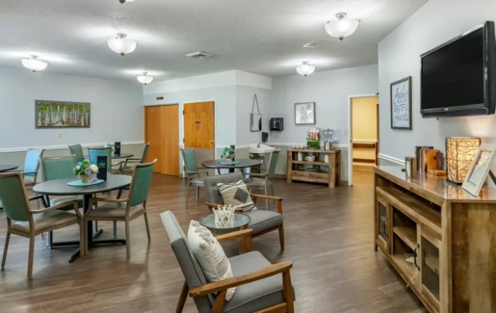 A modern, well-lit interior room with comfortable seating and wooden flooring.