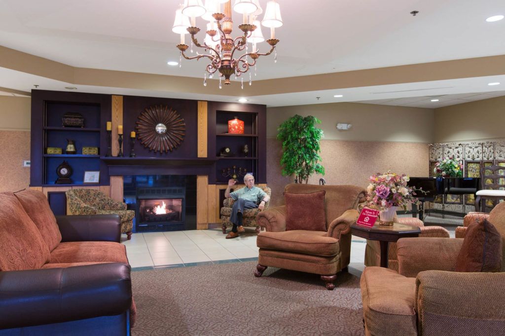 A cozy hotel lobby with comfortable seating and a warm fireplace.