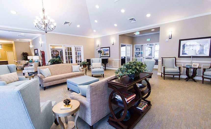 A spacious and well-lit living room with comfortable seating and modern decor.