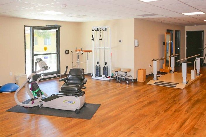 An indoor gym with various exercise equipment and workout machines.