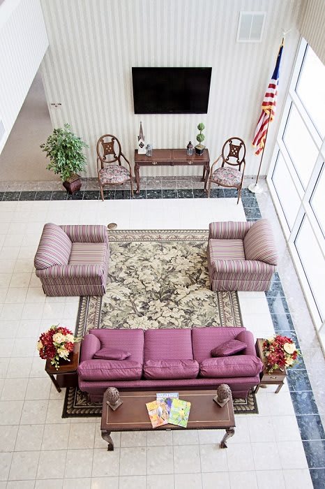 A well-furnished lobby area featuring comfortable seating and decorative elements.