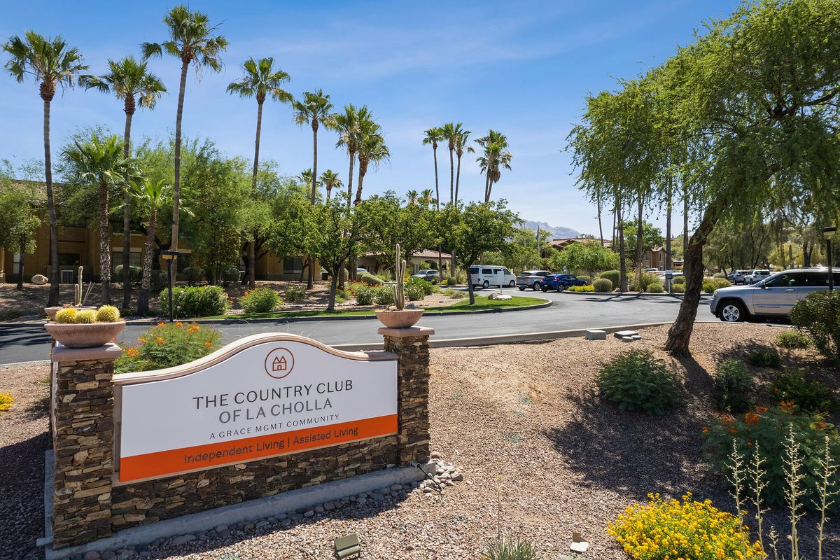 Entrance to the Country Club of a Desert Community with Palm Trees and a Desert Landscape.
