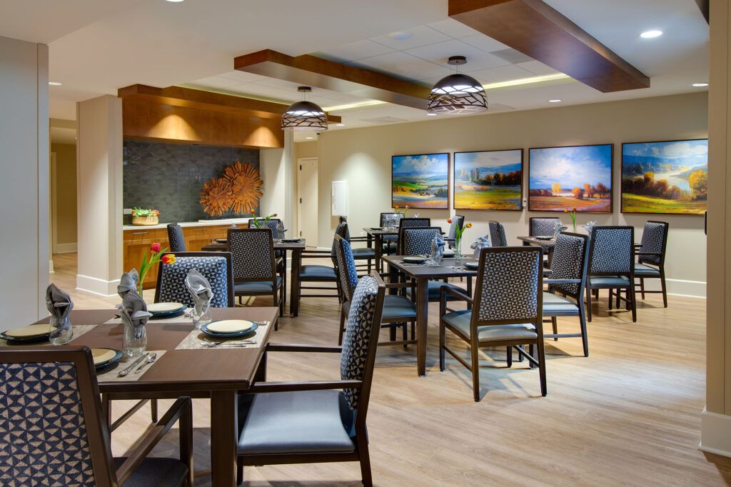 A cozy restaurant dining area with neatly arranged tables and artwork on the walls.