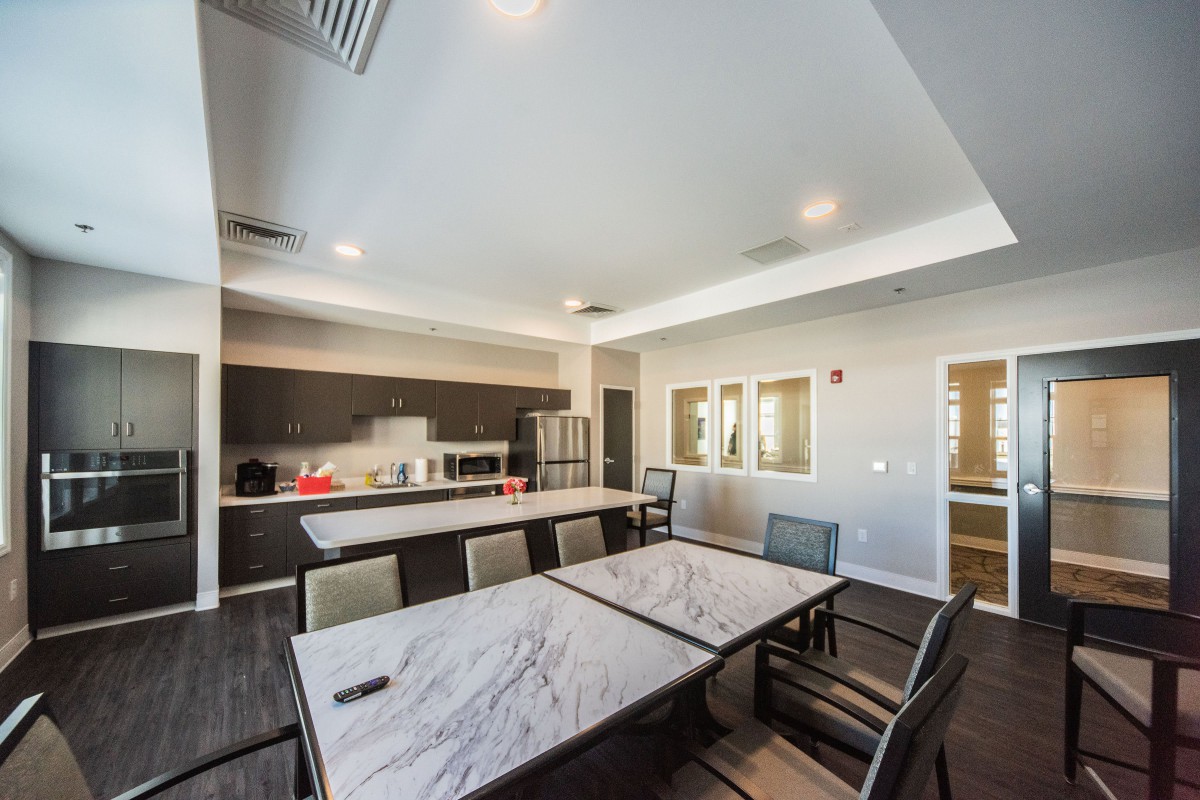 A modern kitchen and dining area with a table and chairs, featuring contemporary interior design.