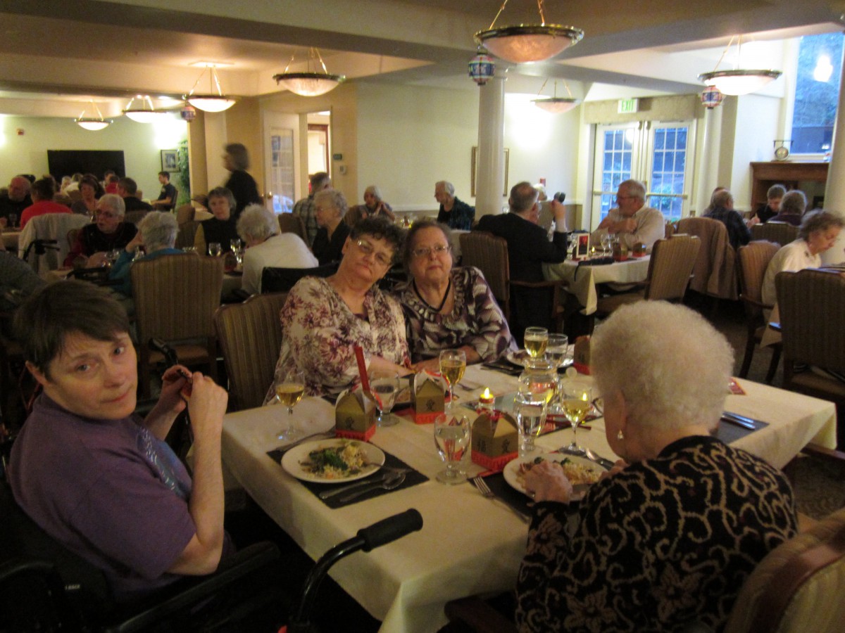 A group of seniors enjoying a meal together at a restaurant.