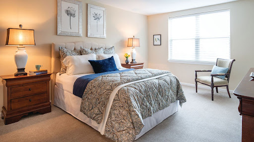 A cozy and stylishly decorated bedroom featuring a comfortable bed, soft linens, and natural light from the window.