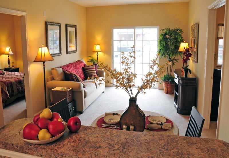 A cozy living room with warm lighting, a comfortable sofa, and elegant decor.