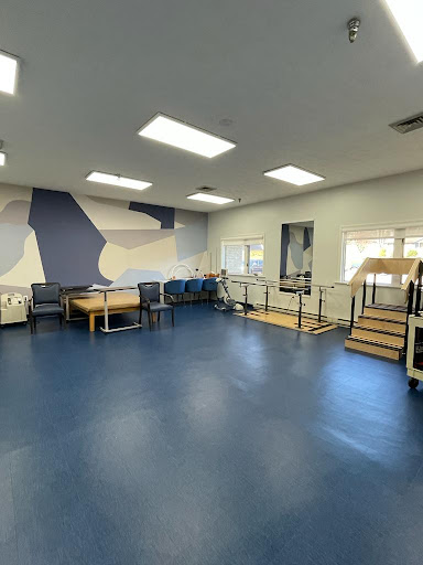 A spacious therapy room designed for rehabilitation with modern amenities and a calming color scheme.