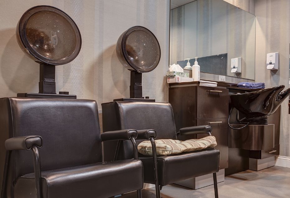 Vintage salon with hair dryers and comfortable seating.
