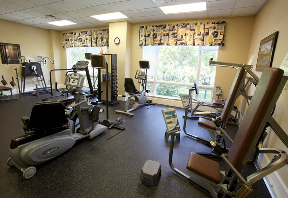 A well-equipped gym featuring various exercise machines and workout equipment.